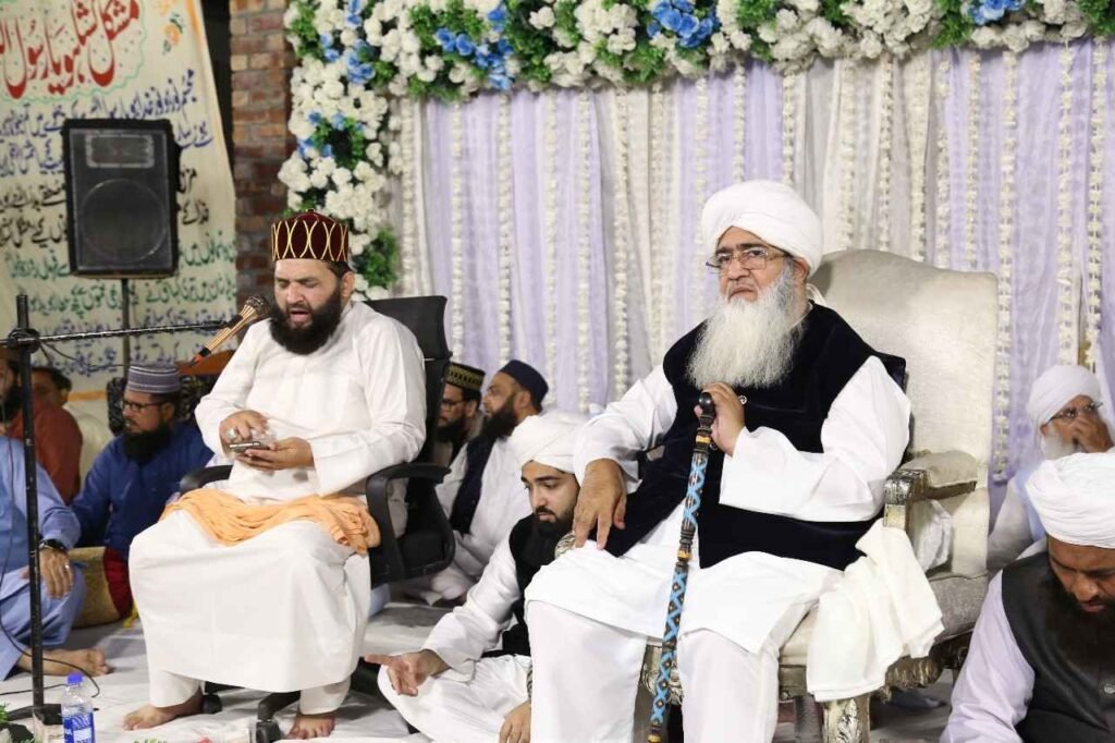 Shaykh Muhammad Mohsin Munawar Yousafi, the esteemed Islamic spiritual guide (Murshid), delivering a passionate discourse, seated and wearing a white turban and dark vest.